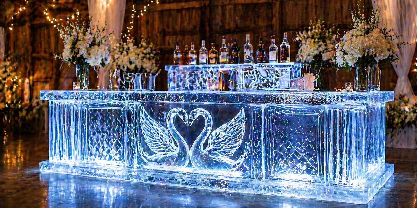 Swan-shaped ice bar display with raised clear wings and a glowing bar setup behind it.